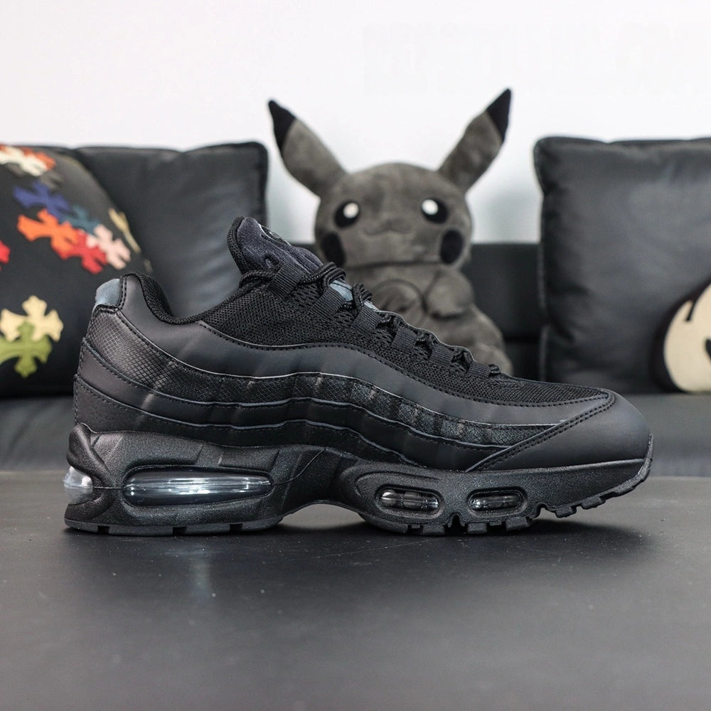 Air Max 95 OG Black Anthracite 2025 - Pair Tongue Top Down Close Up on Dark Background Showing Silver Anthracite Grey Embroidered Oval Airmax Badge on Black Mesh Tongue