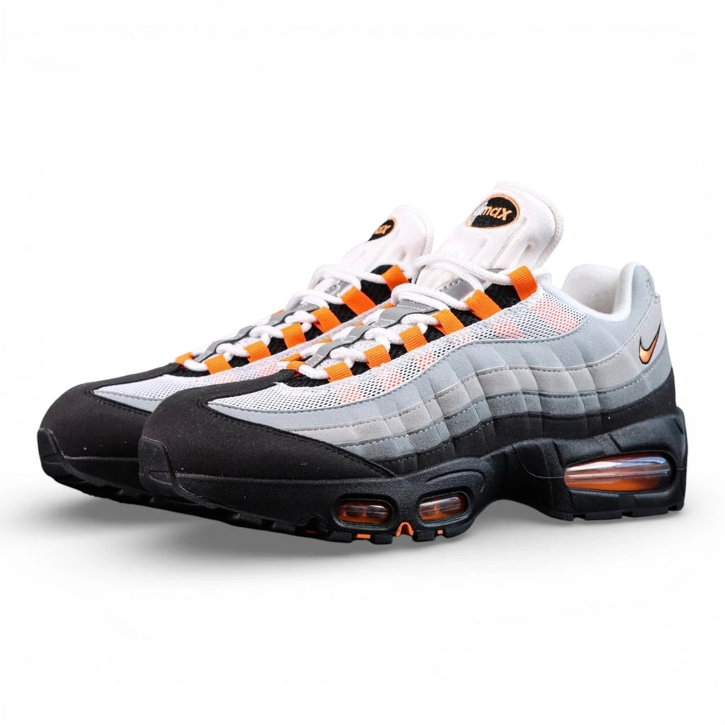 Air Max 95 OG Bright Mandarin 2.0 2025 - Pair Heel Rear View with Pikachu on Sofa Showing Grey Suede Heel Badge with Black Nike Air Text and Bright Mandarin Orange Swoosh and Orange Translucent Heel Air Units