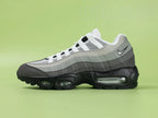 Air Max 95 OG Grey Gradient - Outsole View on Green Background Showing Full Black AM95 Square Block Waffle Tread with Central Translucent Window Revealing 25 PSI Insole Graphic