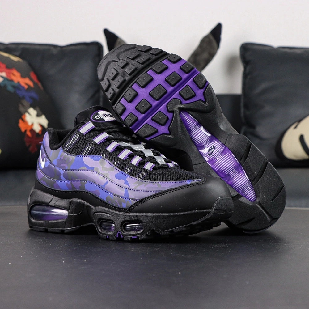 Air Max 95 OG Purple Camo 2025 - Pair Three Quarter Lateral View on Dark Background Showing Full Upper Construction Glossy Purple Camo Spine White Swoosh Purple Air Units and Black Midsole