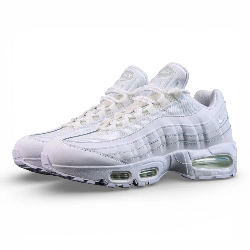 Air Max 95 OG White Pure Platinum 2025 - Pair Heel Rear View with Pikachu on Sofa Showing White Heel Badge with White Nike Air Text Tonal White Swoosh and Translucent Clear Green Tinted Heel Air Units