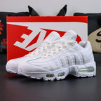 Air Max 95 OG White Pure Platinum 2025 - Single Lateral Full Side View with Pikachu on Sofa Showing Full White Upper White Leather Toe Box White Mesh Base Pure Platinum Gradient Spine Tonal White Swoosh and Clear Air Units