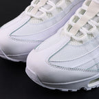 Air Max 95 OG White Pure Platinum 2025 - Pair Heel Rear Angled View with Pikachu on Sofa Showing White Heel Badge Tonal White Swoosh Pure Platinum Upper Heel Panel and Translucent Clear Heel Air Units