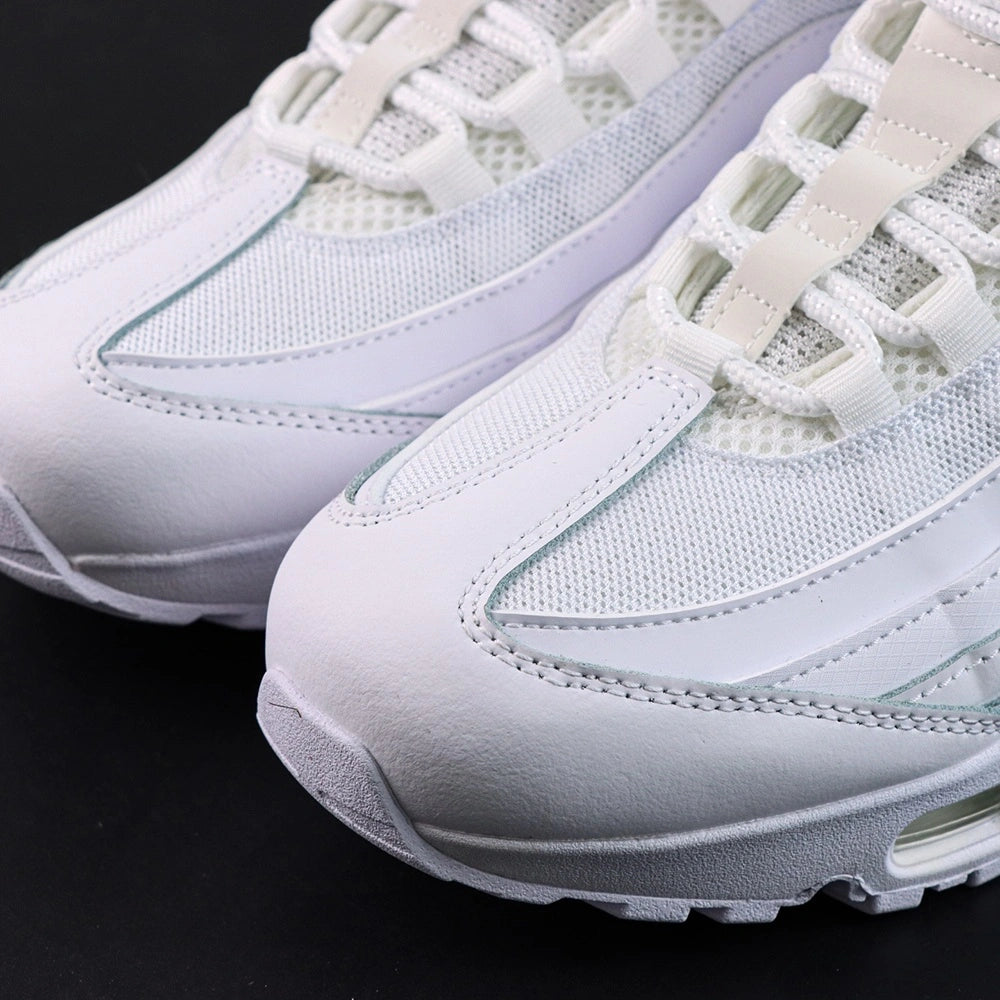 Air Max 95 OG White Pure Platinum 2025 - Pair Heel Rear Angled View with Pikachu on Sofa Showing White Heel Badge Tonal White Swoosh Pure Platinum Upper Heel Panel and Translucent Clear Heel Air Units