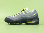 Air Max 95 OG Neon CT1689-001 - Outsole View on Green Background Showing Black AM95 Square Block Waffle Tread Neon Yellow Forefoot Rubber Section and Central Translucent Window with 25 PSI Insole Graphic