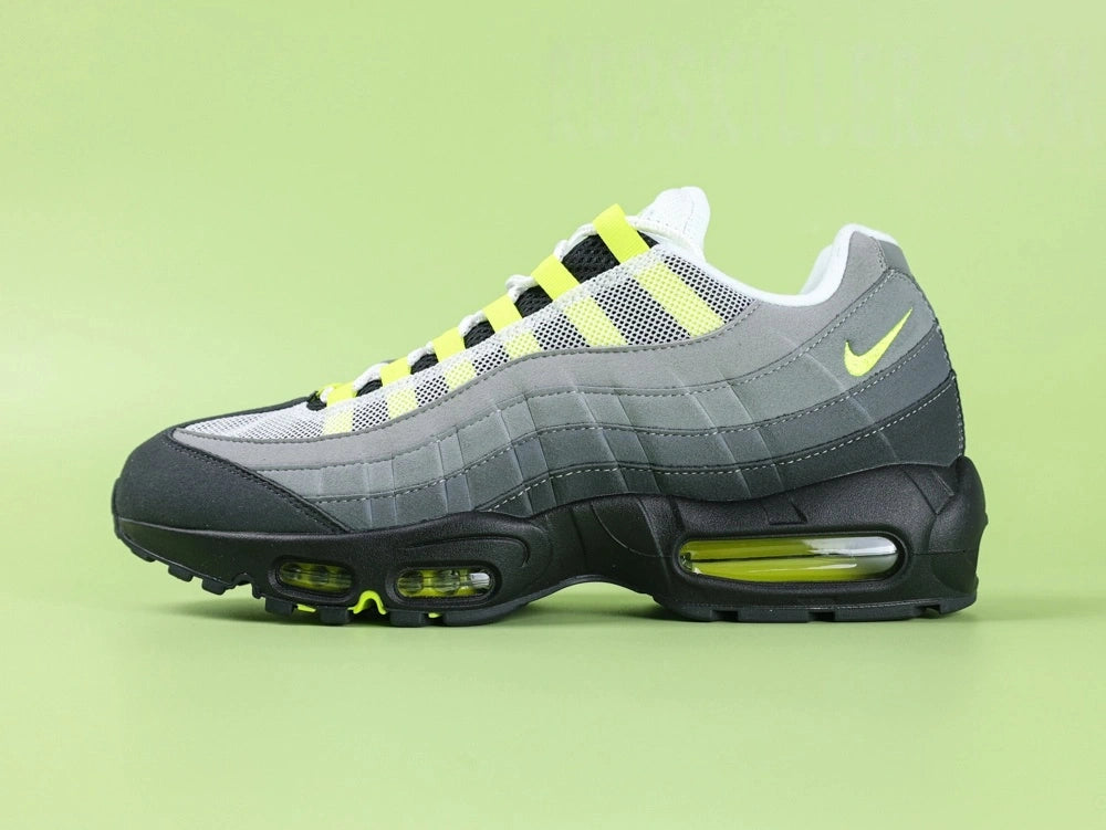 Air Max 95 OG Neon CT1689-001 - Outsole View on Green Background Showing Black AM95 Square Block Waffle Tread Neon Yellow Forefoot Rubber Section and Central Translucent Window with 25 PSI Insole Graphic