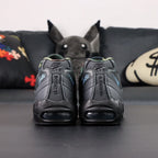 Air Max 95 SP Corteiz Aegean Storm - Single Lateral Full Side View with Pikachu on Sofa Showing Full Black Upper Diamond Quilted Mesh Iridescent Blue Swoosh White Corteiz Script on Heel Spine and Steel Blue Air Units