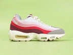 Air Max 95 TT Anatomy of Air - Toe Box Top Down Close Up on Green Background Showing Medium Grey Grid Suede Mudguard White Quilted Mesh White Pink Spine Panels and Sky Blue Tongue Lace Loop