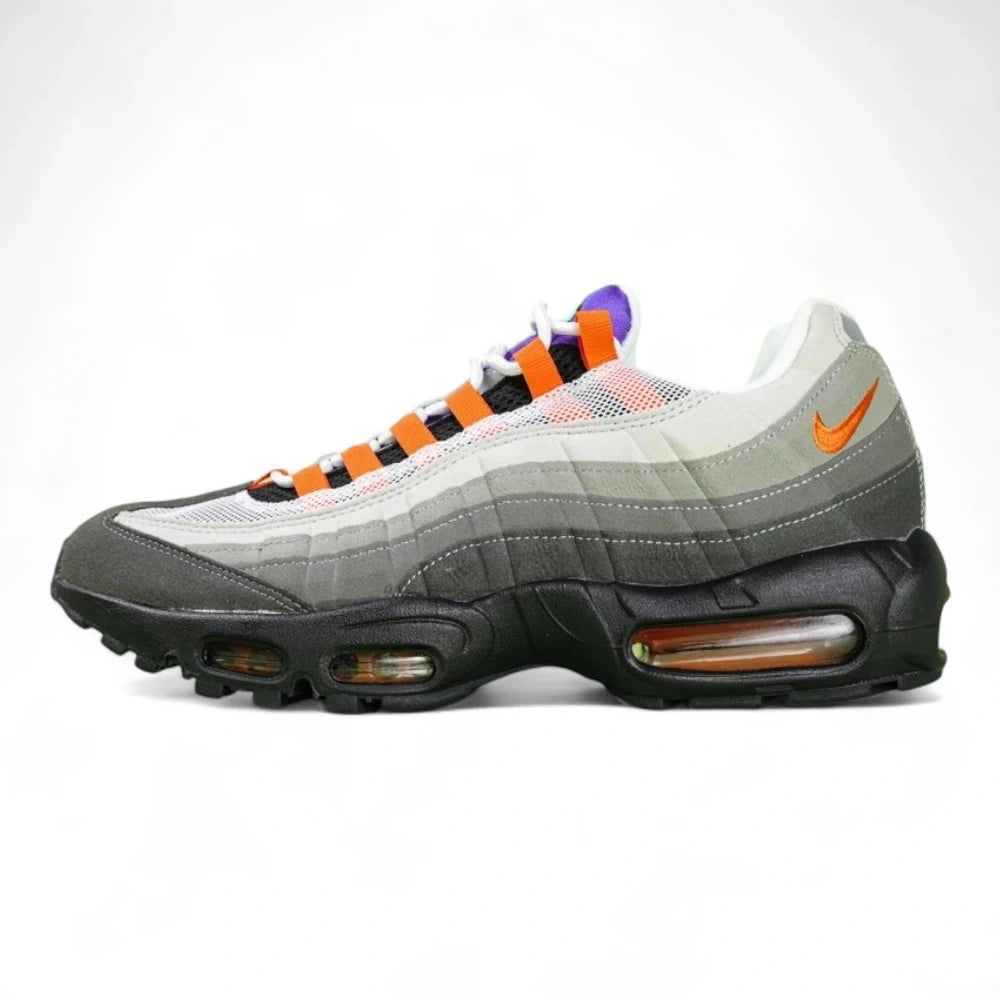 Air Max 95 TT Greedy - Lateral Spine Swoosh Close Up on Green Background Showing Medium Grey Suede Spine Panel with Orange Embroidered Mini Swoosh and Dark Charcoal Lower Spine Panel with Grey Contrast Stitching