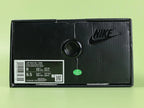 Air Max 95 x Comme des Garçons White - Toe Box Close Up on Green Background Showing Matte White Suede Mudguard White Mesh Quarter Panel and Reflective Grey Lace Loops