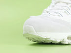 Air Max 95 x Comme des Garçons White - Heel Angled View on Green Background Showing Silver AM95 Heel Stabiliser AIR Text White Flat Laces and White Translucent Heel Air Unit
