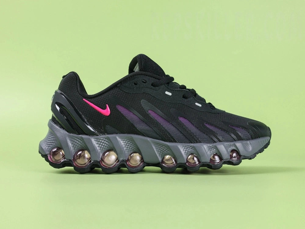 Air Max Dn8 Black Purple - Toe Box Top Down View on Green Background Showing Black Engineered Mesh Upper Black TPU Overlays and Hot Pink Swoosh Visible at Midfoot