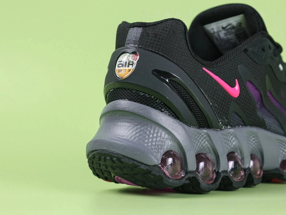 Air Max Dn8 Black Purple - Tongue Close Up on Green Background Showing White Oval airMAX Rubber Badge with Hot Pink Border Black Lettering and Orange Circular Dn8 Insole Badge