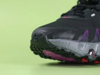 Air Max Dn8 Black Purple - Swoosh Close Up on Green Background Showing High-Gloss Hot Pink Lacquered 3D Sculptural Swoosh on Black Engineered Mesh Midfoot with Deep Purple Hex Mesh and Black Flame TPU Overlays