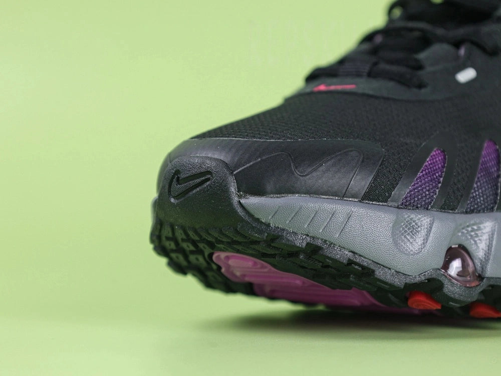 Air Max Dn8 Black Purple - Swoosh Close Up on Green Background Showing High-Gloss Hot Pink Lacquered 3D Sculptural Swoosh on Black Engineered Mesh Midfoot with Deep Purple Hex Mesh and Black Flame TPU Overlays