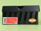 Air Max Dn8 Black Volt - Outsole View on Green Background Showing Full Black Rubber Outsole with Red Circular Traction Studs Grey Translucent Air Window and Gold Circular Dn Badge at Midfoot