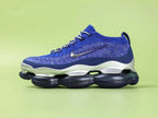 Air Max Scorpion FK Blue Fury - Outsole View on Green Background Showing Full Deep Navy Blue Scorpion Air Pod Outsole with Connected Multi-Pod Form and V-Shaped Herringbone Traction Grooves