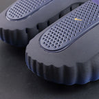 Mind 001 Blackened Blue 2026 - Side profile gold Swoosh pair