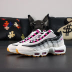 SB x Air Max 95 Cactus Flower - Toe Box Close Up on Black Background Showing White Suede Mudguard Light Grey Suede Lower Spine White Large-Hole Mesh Quarter Panel and Cactus Flower Lace Keeper Tabs