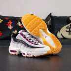 SB x Air Max 95 Cactus Flower - Forefoot Lateral Close Up on Black Background Showing White Suede Toe Box Light Grey Suede Overlays Black Leather Spine Overlays and Cactus Flower Fuchsia Translucent Air Unit at Forefoot
