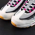 SB x Air Max 95 Cactus Flower - Rear Heel View of Both Shoes on Grey Background Showing Cactus Flower Embroidered NIKE SB AIR Text and Mini Swoosh on Black Leather Heel Counter with White Midsole and Honey Gum Outsole