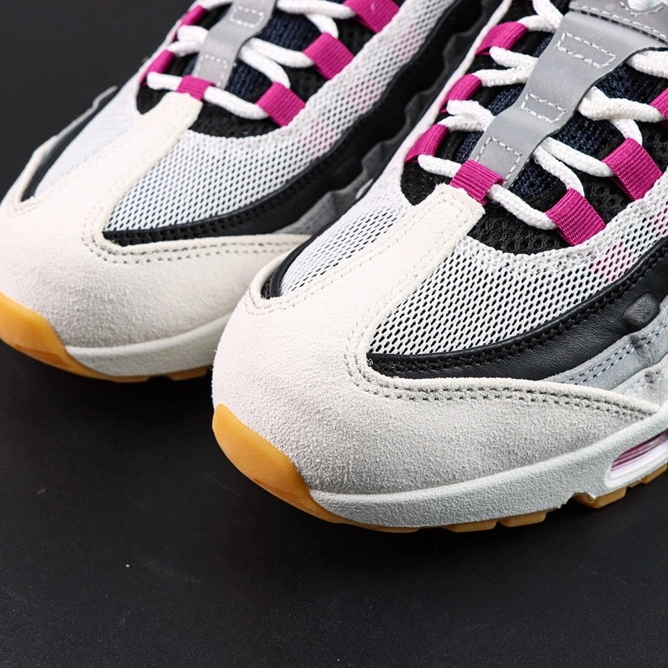 SB x Air Max 95 Cactus Flower - Rear Heel View of Both Shoes on Grey Background Showing Cactus Flower Embroidered NIKE SB AIR Text and Mini Swoosh on Black Leather Heel Counter with White Midsole and Honey Gum Outsole