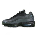 Air Max 95 SP Corteiz Aegean Storm - Single Lateral Full Side View with Pikachu on Sofa Showing Full Black Upper Diamond Quilted Mesh Black Charcoal Gradient Spine Iridescent Blue Swoosh White Corteiz Script and Steel Blue Air Units