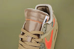 Off-White x Air Max 90 Desert Ore - Outsole View on Olive Background Showing Full Sand Desert Ore AM90 Rubber Outsole with Square-Block and Wave-Pattern Traction Debossed NIKE Text at Midfoot and Teal Zip-Tie Visible at Heel