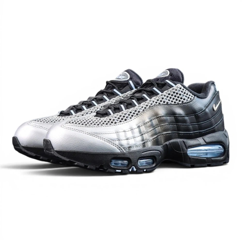 Palace x Air Max 95 Big Bubble Metallic Silver 2026 - Full Lateral Profile View on Dark Background Showing Metallic Silver Perforated Leather Toe Box Black Smooth Leather Spine Overlays Palace Oval Tongue Badge and Ice Blue Big Bubble Air Units