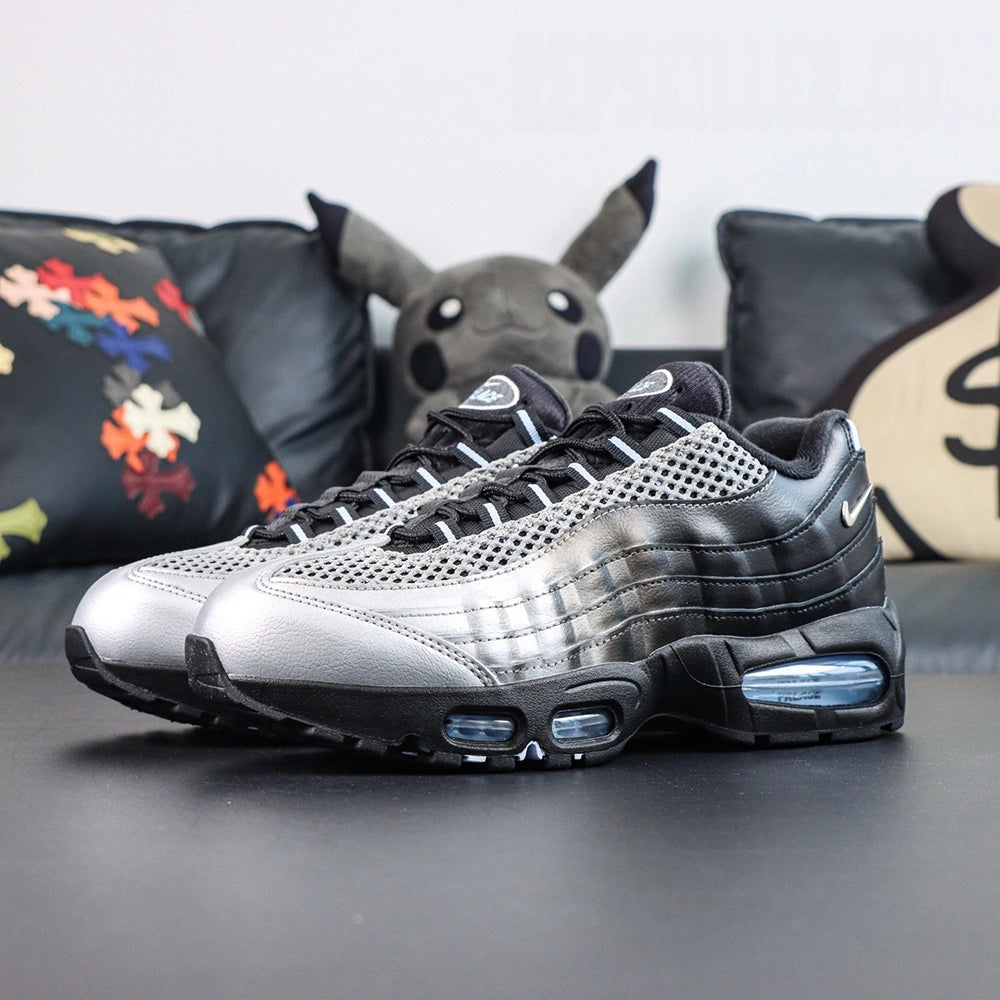 Palace x Air Max 95 Big Bubble Metallic Silver 2026 - Tongue Top Down View on Dark Background Showing Palace Oval Badge with White PALACE Embroidery on Black Ground and Black Suede Ankle Collar