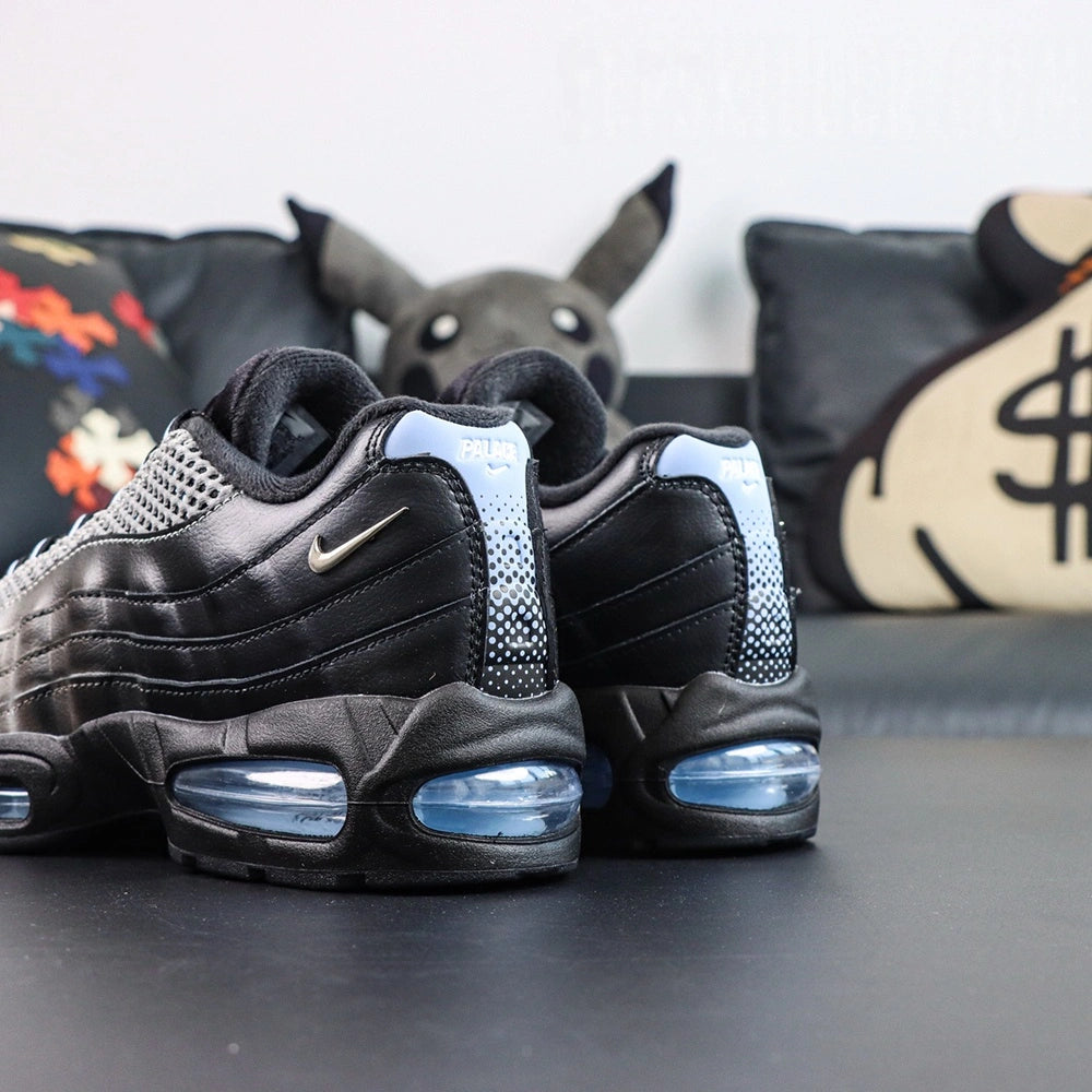 Palace x Air Max 95 Big Bubble Metallic Silver 2026 - Rear Heel View of Both Shoes on Dark Background Showing White-to-Black Halftone Dot Gradient on Heel Tab with White PALACE Text at Top and Ice Blue Big Bubble Air Unit at Heel