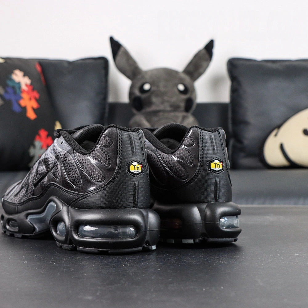 Paris Saint-Germain x Air Max Plus Black Particle Grey - Lateral Profile View with Red Shoebox on Dark Background Showing Black Patent Leather TN Upper Particle Grey Hex Mesh PSG Lettering and Yellow Tn AIR Heel Badge