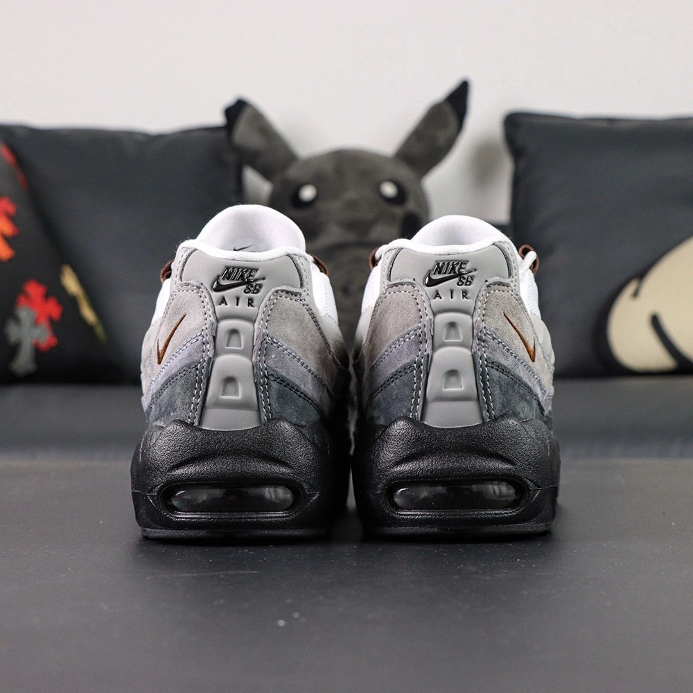 SB x Air Max 95 Cacao Wow 2026 - Full Lateral Profile View on Dark Background Showing White Large-Hole Mesh Toe Box White Grey Gradient Vintage Suede Spine Overlays Cacao Wow Brown Mini Swoosh and Black Midsole