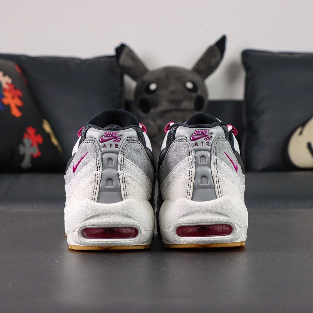 SB x Air Max 95 Cactus Flower - Lateral Profile and Outsole View on Dark Background Showing White Grey Gradient AM95 Upper Fuchsia Grosgrain Lace Tabs Fuchsia Air Units and Full Honey Gum AM95 Square-Block Waffle Outsole