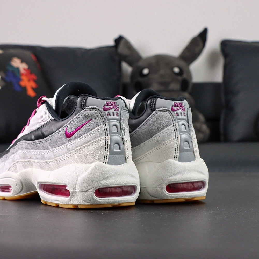 SB x Air Max 95 Cactus Flower - Three-Quarter Top View of Both Shoes on Dark Background Showing White Grey Gradient Suede Spine Overlays Cactus Flower Fuchsia Grosgrain Ribbon Lace Tabs and White Rope Laces