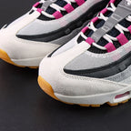 SB x Air Max 95 Cactus Flower - Tongue Top Down View on Dark Background Showing SB x AM95 Oval Badge with Black Ground Cactus Flower Fuchsia Embroidered Air Max Script and Fuchsia Grosgrain Ribbon Lace Tabs