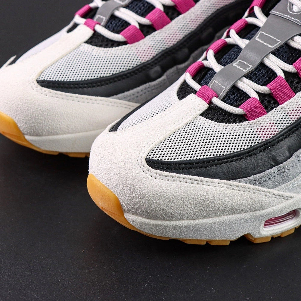 SB x Air Max 95 Cactus Flower - Tongue Top Down View on Dark Background Showing SB x AM95 Oval Badge with Black Ground Cactus Flower Fuchsia Embroidered Air Max Script and Fuchsia Grosgrain Ribbon Lace Tabs