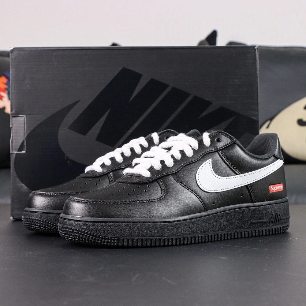 Supreme x Air Force 1 Low Box Logo Black White White Laces - pair overhead flat lay black background white laces