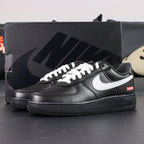 Supreme x Air Force 1 Low Box Logo Black White White Laces - pair overhead flat lay black background white laces