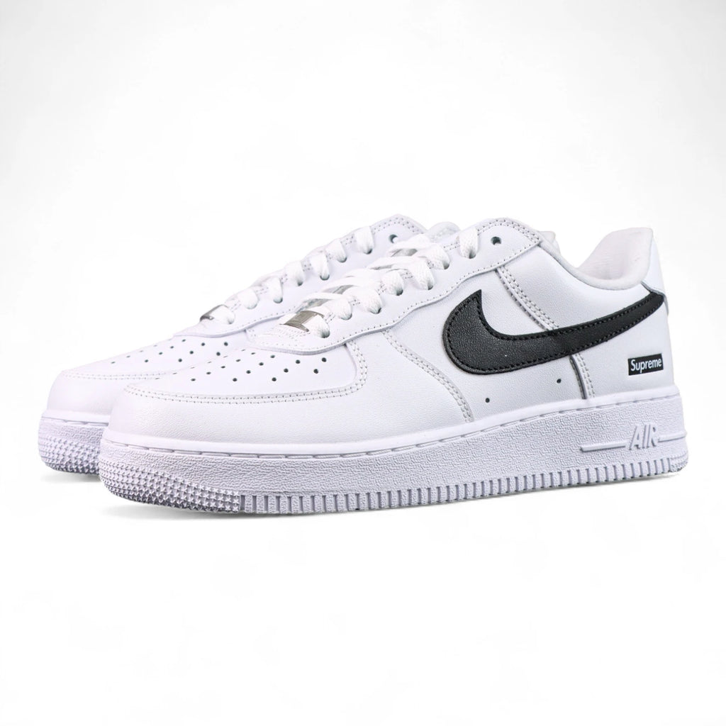 Supreme x Air Force 1 Low Box Logo White Black - pair three quarter front view black Swoosh silver Supreme badge black background