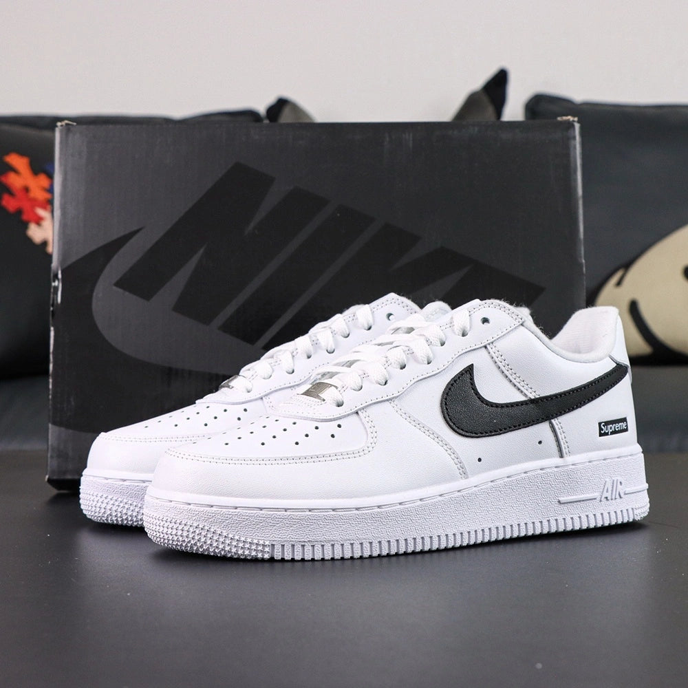 Supreme x Air Force 1 Low Box Logo White Black - pair overhead flat lay black background black Swoosh Supreme badge