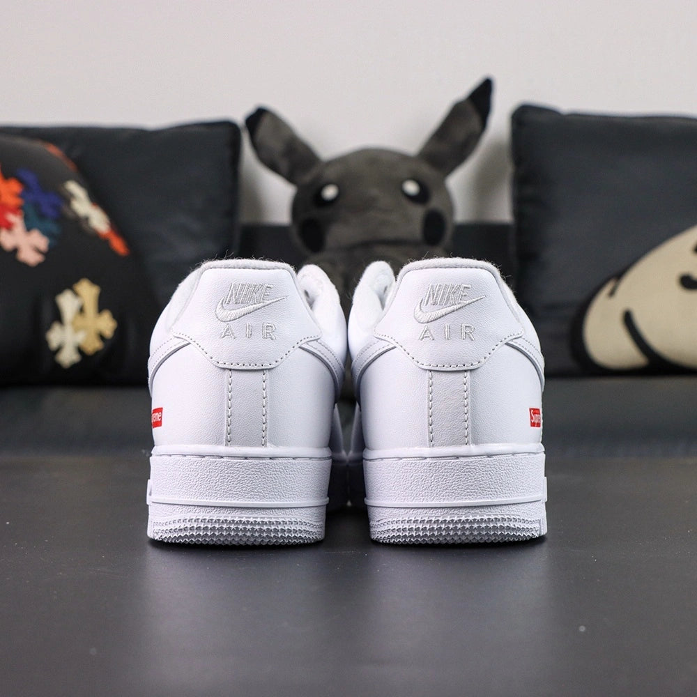 Supreme x Air Force 1 Low Box Logo White - pair three quarter view with black Nike box Pikachu