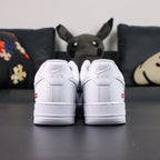 Supreme x Air Force 1 Low Box Logo White - pair three quarter view with black Nike box Pikachu