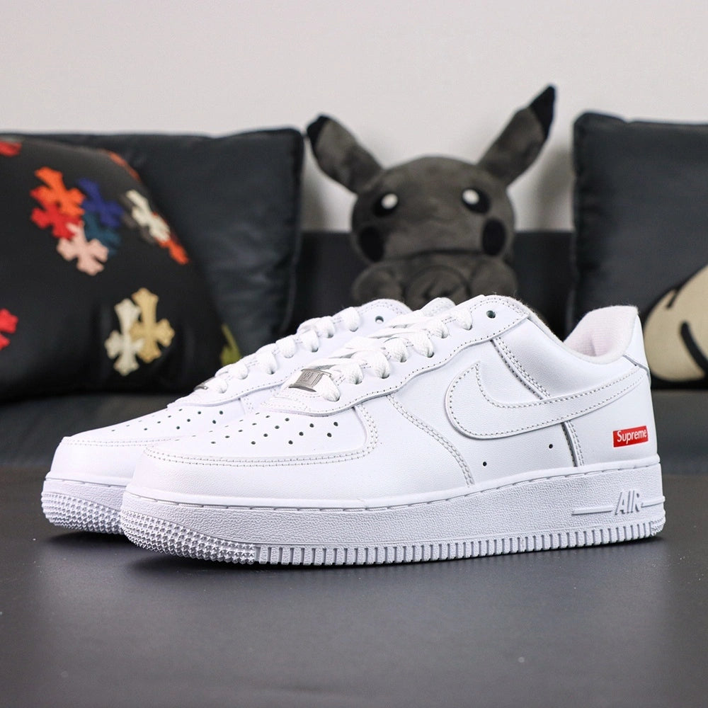 Supreme x Air Force 1 Low Box Logo White - pair overhead flat lay black background red Supreme badge