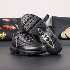 Supreme x Air Max 95 Lux Black - Toe Box Close Up on Dark Background Showing Premium Black Smooth Leather Toe Box Perforated Leather Side Wall and Tone-on-Tone Debossed Supreme New York Cursive Script on Quarter Panel