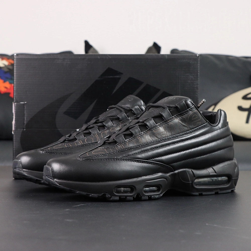 Supreme x Air Max 95 Lux Black - Full Lateral Profile View on White Background Showing Complete Triple Black Premium Leather AM95 Lux Construction Debossed Supreme Script and Full Black Midsole Outsole