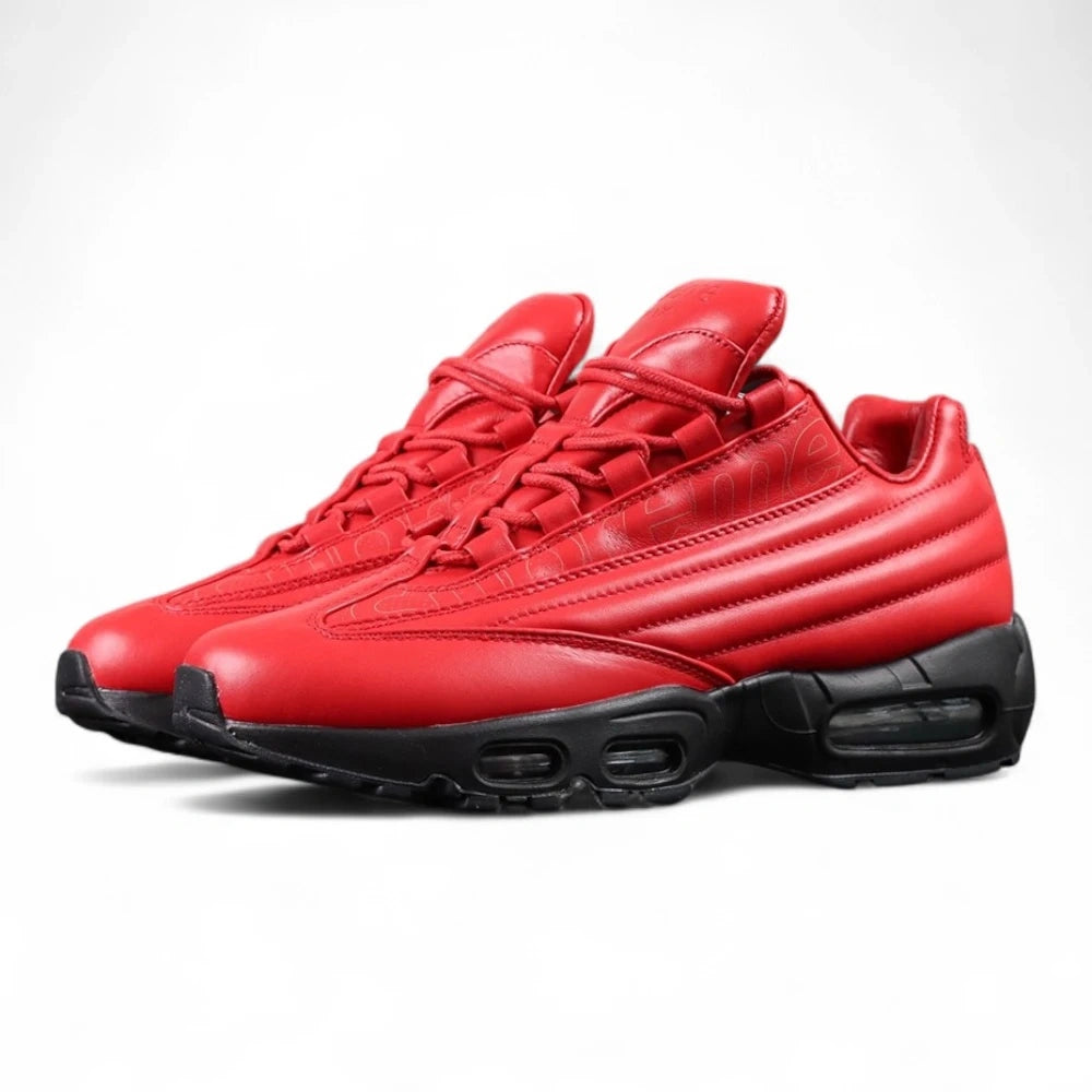 Supreme x Air Max 95 Lux Gym Red - Full Lateral Profile View with Black Shoebox on Dark Background Showing Full Gym Red Premium Leather AM95 Upper Tone-on-Tone Supreme Cursive Script on Quarter Panel and Full Black Midsole Outsole