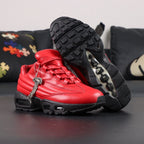 Supreme x Air Max 95 Lux Gym Red - Three-Quarter Lateral Top View of Both Shoes on Dark Background Showing Full Gym Red Leather AM95 Spine Overlay Construction Tone-on-Tone Supreme Script and Black Metal Ball-Chain Dubrae