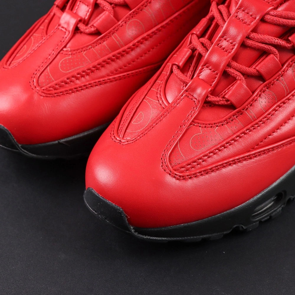 Supreme x Air Max 95 Lux Gym Red - Full Lateral Profile View on Dark Background Showing Complete Gym Red Premium Leather AM95 Lux Upper Tone-on-Tone Supreme Cursive Script and Full Black Midsole Outsole