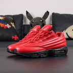 Supreme x Air Max 95 Lux Gym Red - Toe Box Close Up on Dark Background Showing Premium Gym Red Smooth Leather Toe Box Tone-on-Tone Supreme Cursive Script Debossed on Red Leather Quarter Panel and Black Midsole Edge